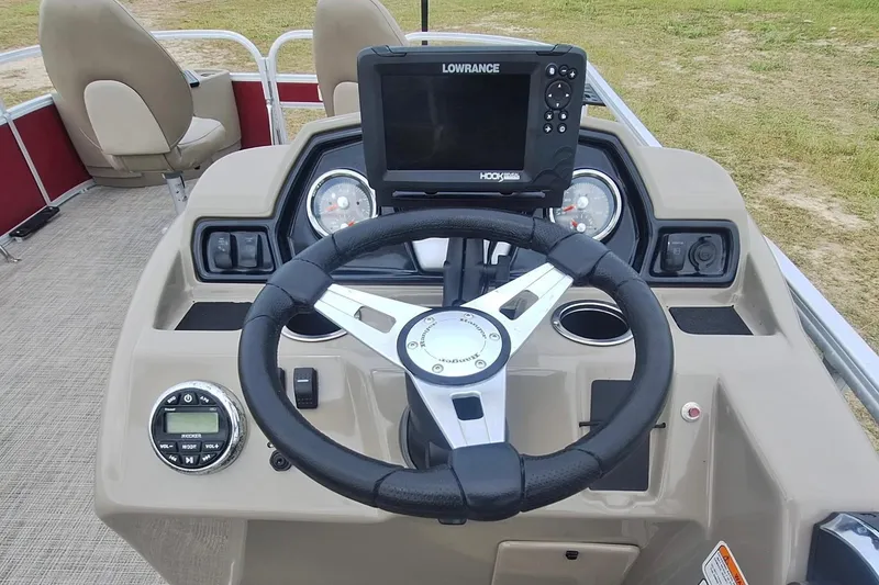Slide: The Image of 2021 Ranger Reata 200F boat dashboard with steering wheel and Lowrance fish finder. - 11