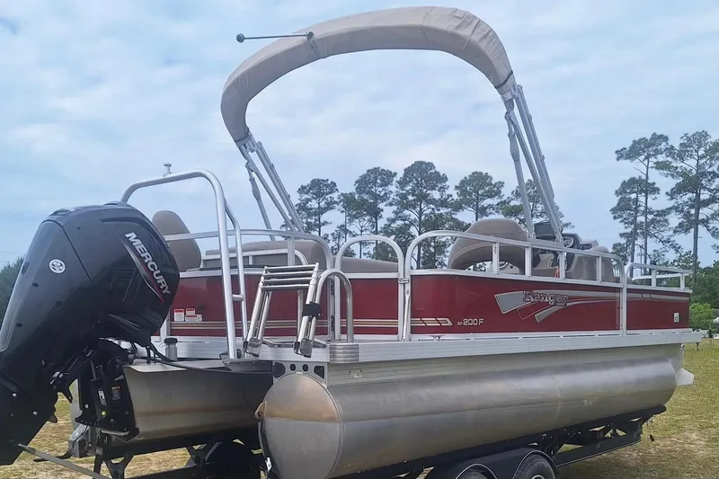 Slide: The Image of 2021 Ranger Reata 200F pontoon boat with Mercury engine, parked on trailer. - 3