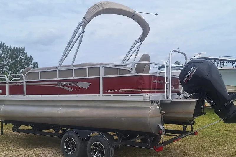 Slide: The Image of 2021 Ranger Reata 200F pontoon boat with Mercury outboard motor on trailer. - 5