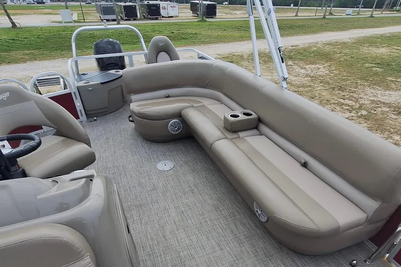Slide: The Image of 2021 Ranger Reata 200F pontoon boat interior with beige seating and cup holders. - 8
