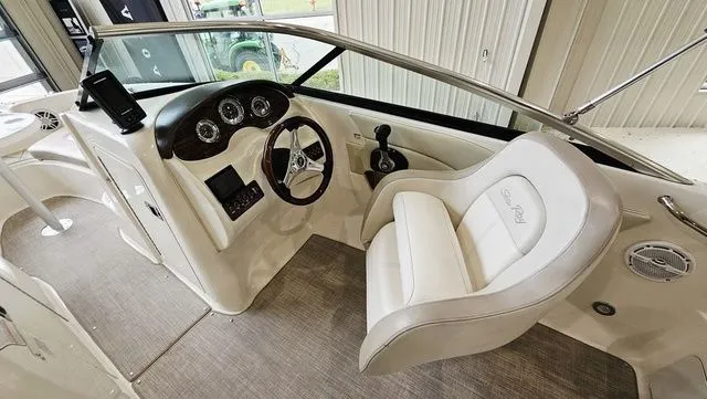 Slide: The Image of Interior of a 2012 Sea Ray 200 Sundeck boat with steering console. - 11
