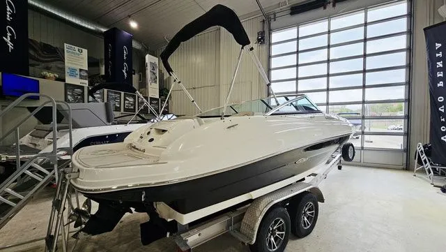 Slide: The Image of 2012 Sea Ray 200 Sundeck boat in a showroom on a trailer. - 4