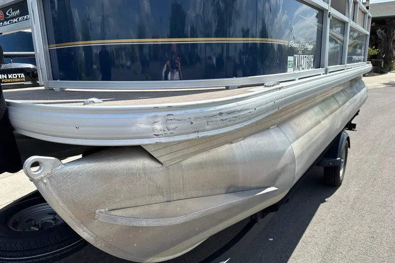 Slide: The Image of 2024 Sun Tracker Bass Buggy 16 XL Select pontoon boat, side view, on trailer. - 15