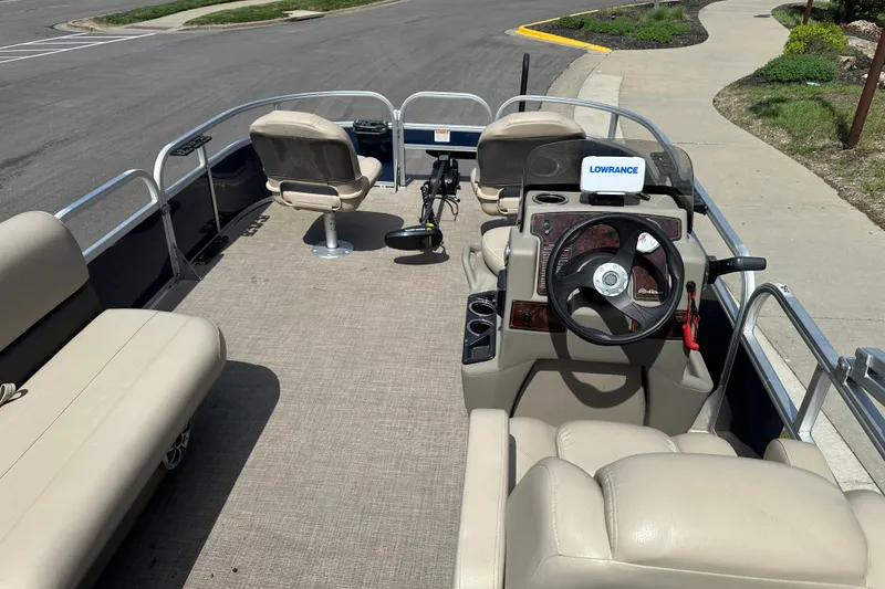 Slide: The Image of 2024 Sun Tracker Bass Buggy 16 XL Select pontoon boat interior with steering console and seating. - 17