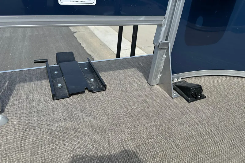 Slide: The Image of 2024 Sun Tracker Bass Buggy 16 XL Select deck detail with metal fittings and textured flooring. - 18