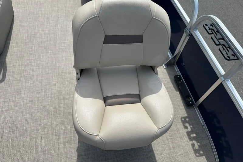 Slide: The Image of 2024 Sun Tracker Bass Buggy 16 XL Select boat seat, beige upholstery, on textured flooring. - 21