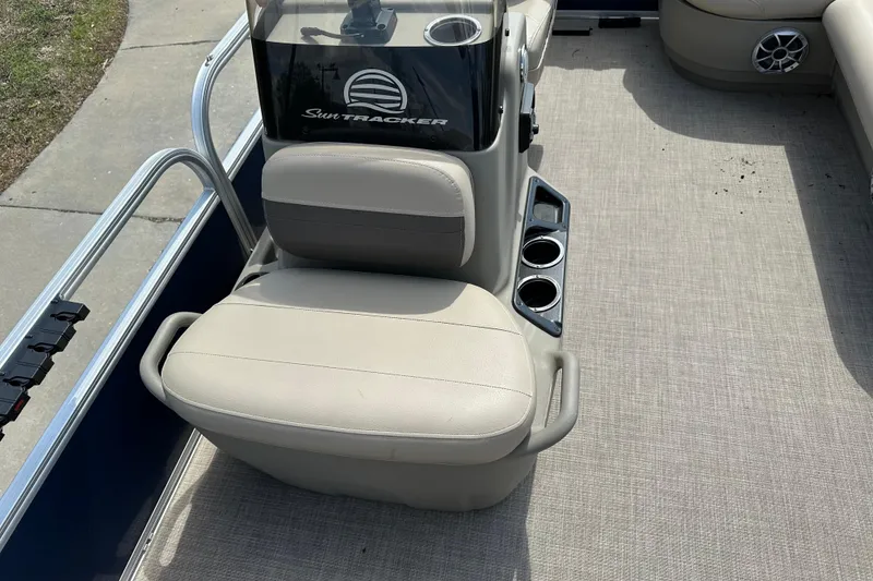 Slide: The Image of 2024 Sun Tracker Bass Buggy 16 XL Select boat interior with beige seating and cup holders. - 23