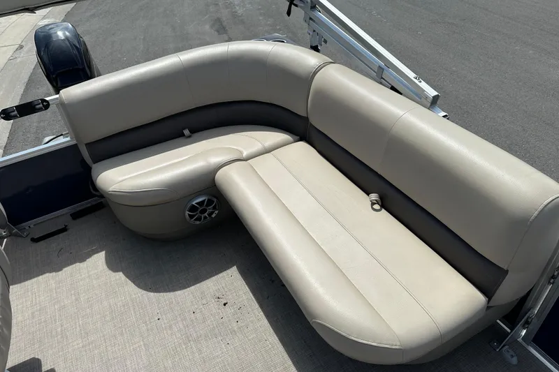 Slide: The Image of 2024 Sun Tracker Bass Buggy 16 XL Select boat seating, beige upholstery, outdoor setting. - 24