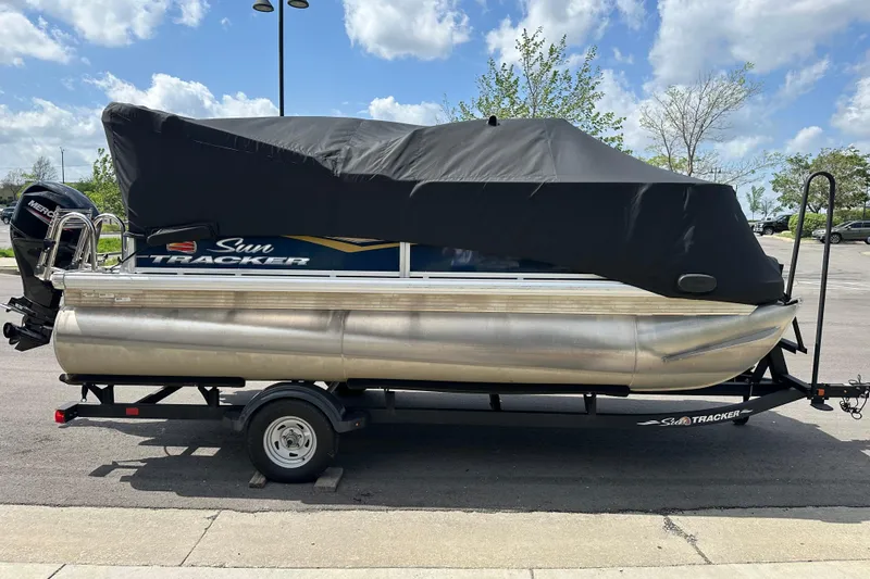 Slide: The Image of 2024 Sun Tracker Bass Buggy 16 XL Select pontoon boat covered on trailer. - 3