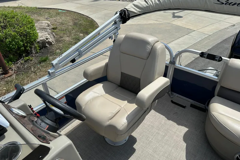 Slide: The Image of 2024 Sun Tracker Bass Buggy 16 XL Select boat interior with beige captain's chair and steering wheel. - 35