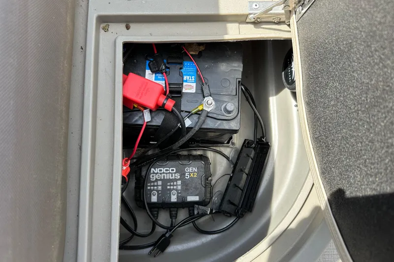 Slide: The Image of Battery compartment of 2024 Sun Tracker Bass Buggy 16 XL Select with NOCO Genius charger. - 37