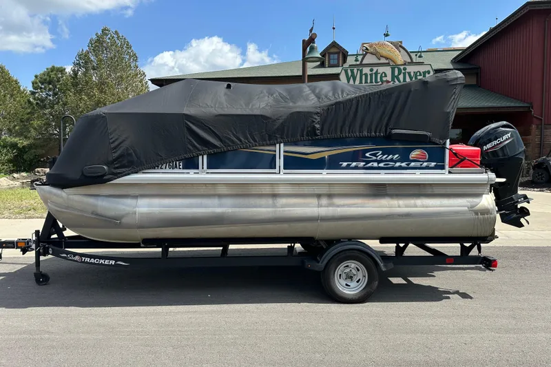 Slide: The Image of 2024 Sun Tracker Bass Buggy 16 XL Select pontoon boat with cover on trailer. - 5