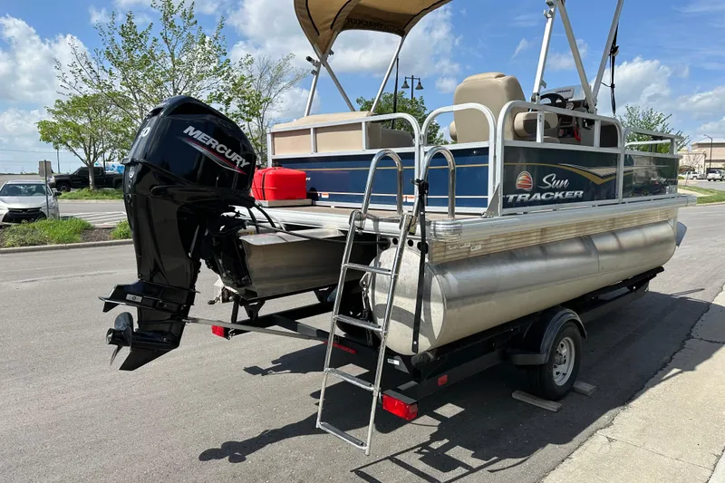 Slide: The Image of 2024 Sun Tracker Bass Buggy 16 XL Select pontoon boat with Mercury engine on trailer. - 7