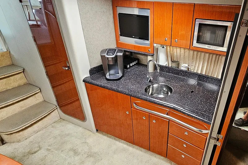 Slide: The Image of Interior of 2006 Formula 37 Performance Cruiser with modern kitchenette and wooden cabinetry. - 11