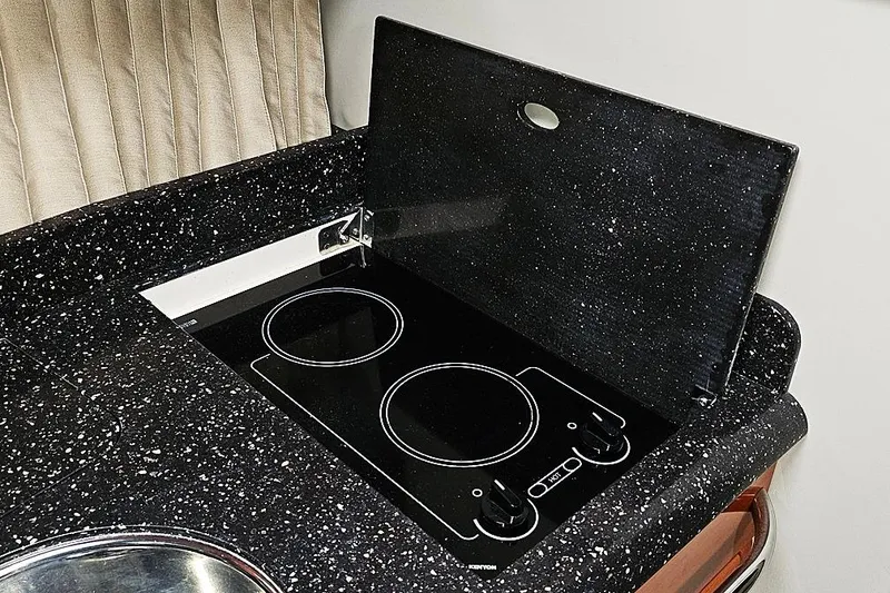 Slide: The Image of 2006 Formula 37 Performance Cruiser kitchen with black speckled countertop and electric stove. - 13