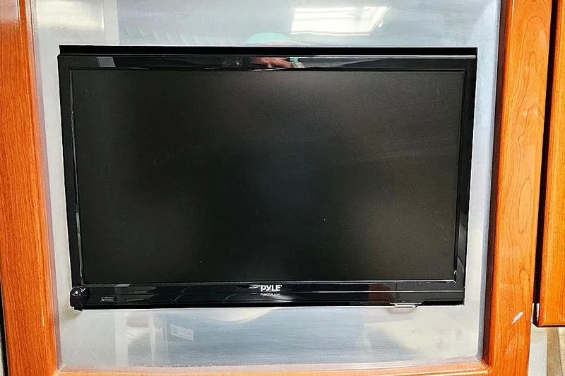 Slide: The Image of Pyle TV mounted on a 2006 Formula 37 Performance Cruiser's wooden interior. - 16