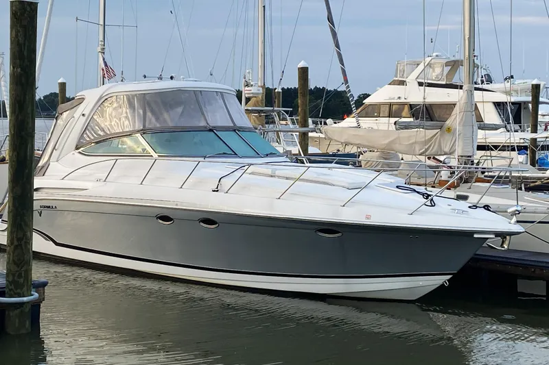 Slide: The Image of 2006 Formula 37 Performance Cruiser docked at marina, showcasing sleek design and luxury features. - 2