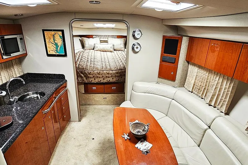 Slide: The Image of Luxurious interior of a 2006 Formula 37 Performance Cruiser with kitchen and cozy seating area. - 3