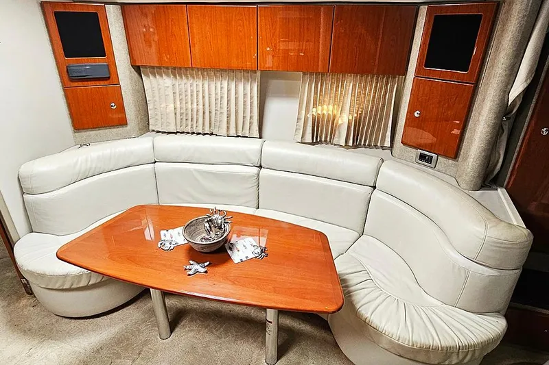 Slide: The Image of Luxurious interior of a 2006 Formula 37 Performance Cruiser with leather seating and wooden table. - 4