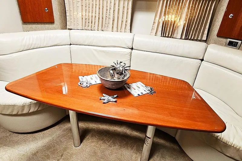 Slide: The Image of Interior of 2006 Formula 37 Performance Cruiser with wooden table and white seating. - 5