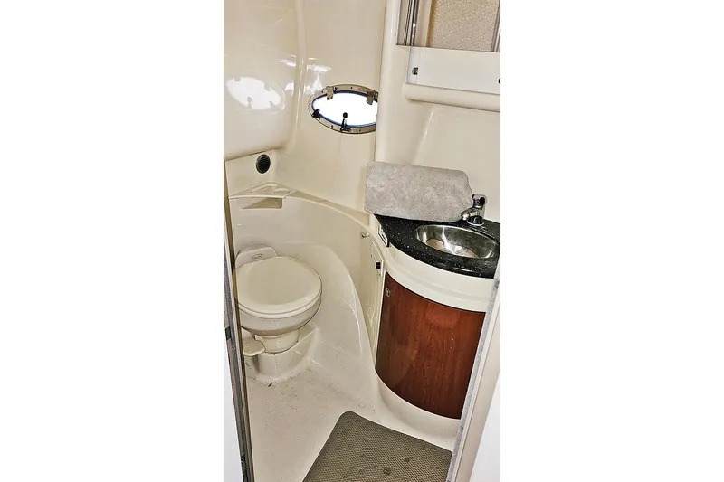 Slide: The Image of 2006 Formula 37 Performance Cruiser bathroom with toilet, sink, and porthole window. - 9