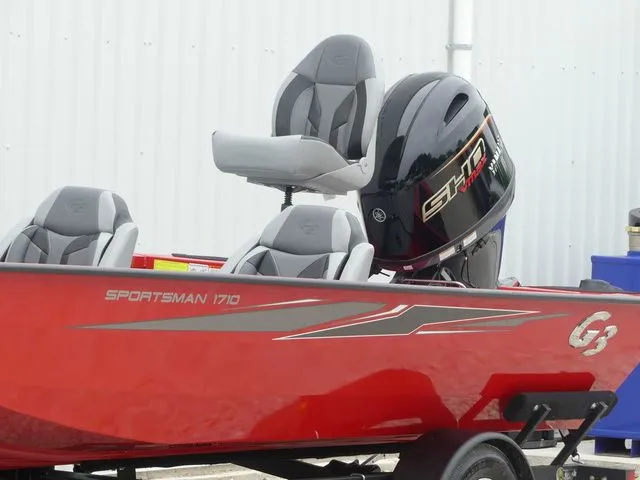 Slide: The Image of Red 2026 G3 Sportsman 1710 boat with gray seats. - 11