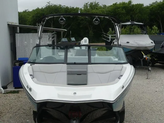 Slide: The Image of 2020 MasterCraft NXT22 boat, front view, parked on gravel lot. - 13