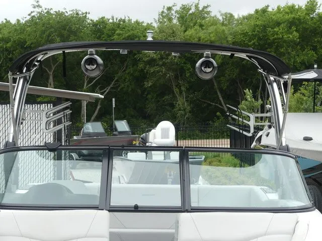 Slide: The Image of 2020 MasterCraft NXT22 boat with speakers and green background. - 14