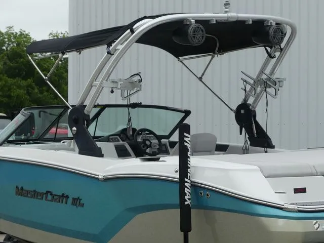 Slide: The Image of 2020 MasterCraft NXT22 boat with blue hull and black canopy. - 15