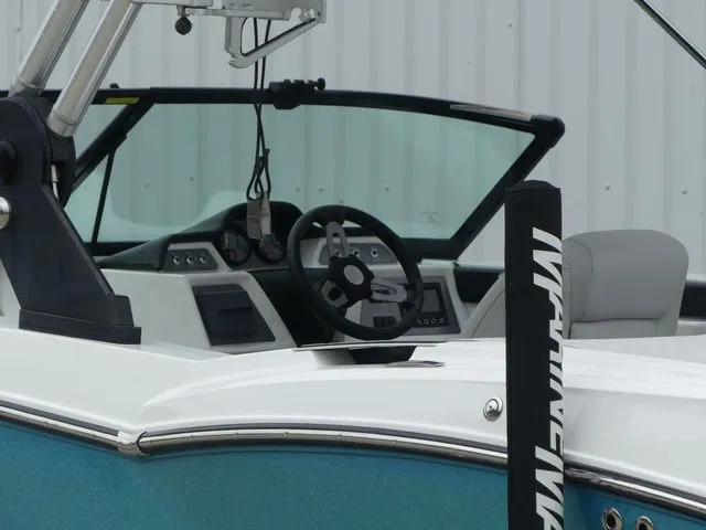 Slide: The Image of 2020 MasterCraft NXT22 boat cockpit with steering wheel and controls. - 18