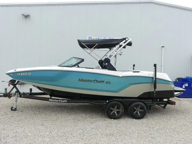 Slide: The Image of 2020 MasterCraft NXT22 boat on trailer in front of warehouse. - 3