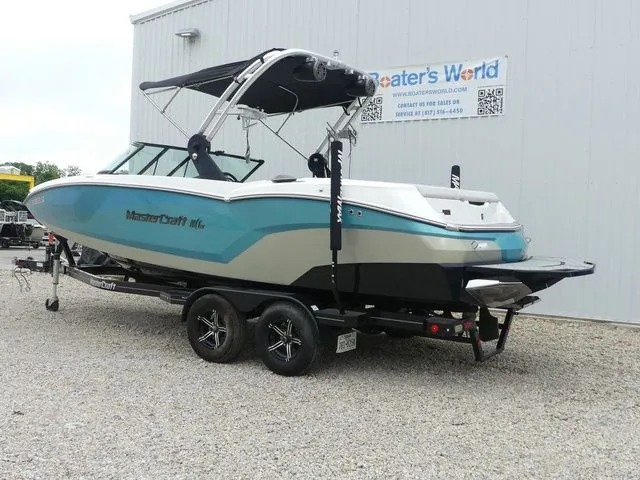 Slide: The Image of 2020 MasterCraft NXT22 boat on trailer outside warehouse. - 4