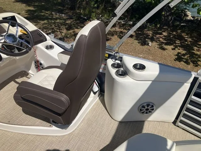 Slide: The Image of Interior of a 2019 Bennington 23 QLC boat with steering wheel and seat. - 13