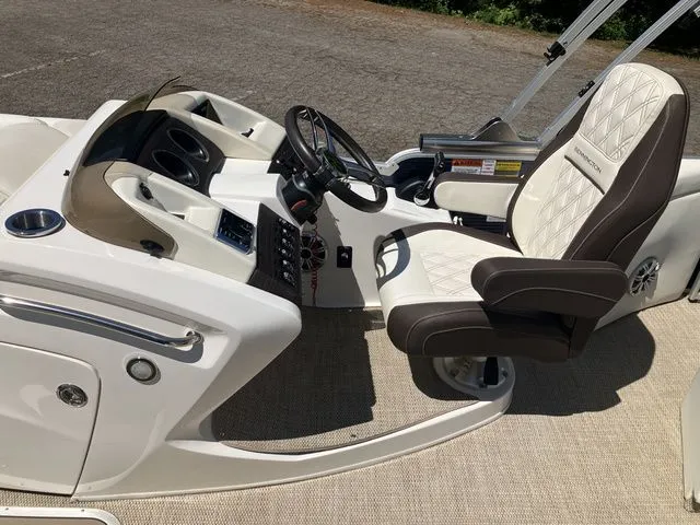 Slide: The Image of Interior of a 2019 Bennington 23 QLC boat with luxurious steering wheel and seat. - 14
