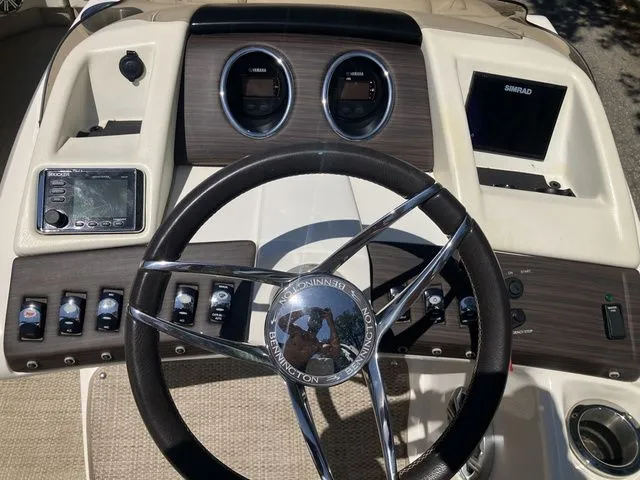 Slide: The Image of Dashboard of a 2019 Bennington 23 QLC boat with steering wheel and instruments. - 16