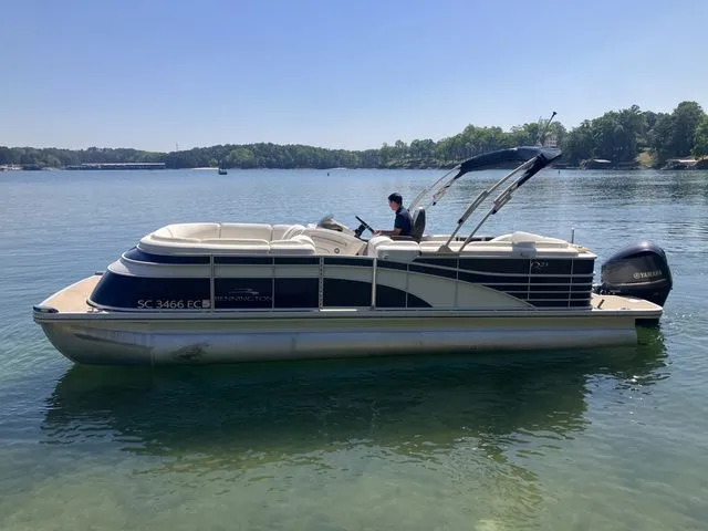 Slide: The Image of 2019 Bennington 23 QLC pontoon boat on a calm lake. - 8