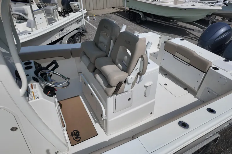 Slide: The Image of 2026 NAUTIC STAR 28 XS boat interior with dual seats and steering console. - 15