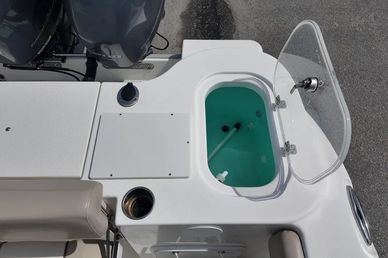 Slide: The Image of 2026 NAUTIC STAR 28 XS boat deck with open storage compartment. - 18