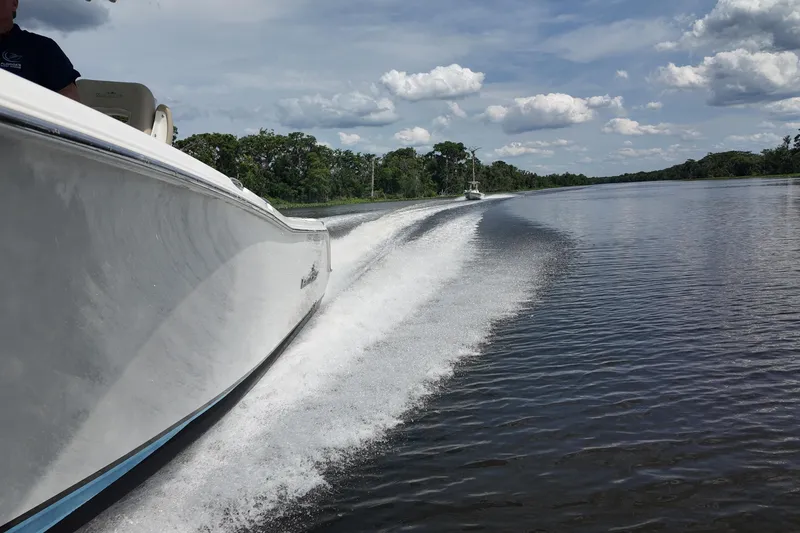 Slide: The Image of 2026 NAUTIC STAR 28 XS boat cruising on a scenic river under a cloudy sky. - 20