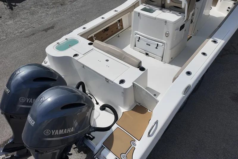 Slide: The Image of 2026 NAUTIC STAR 28 XS boat with Yamaha engines, spacious deck, and seating area. - 5