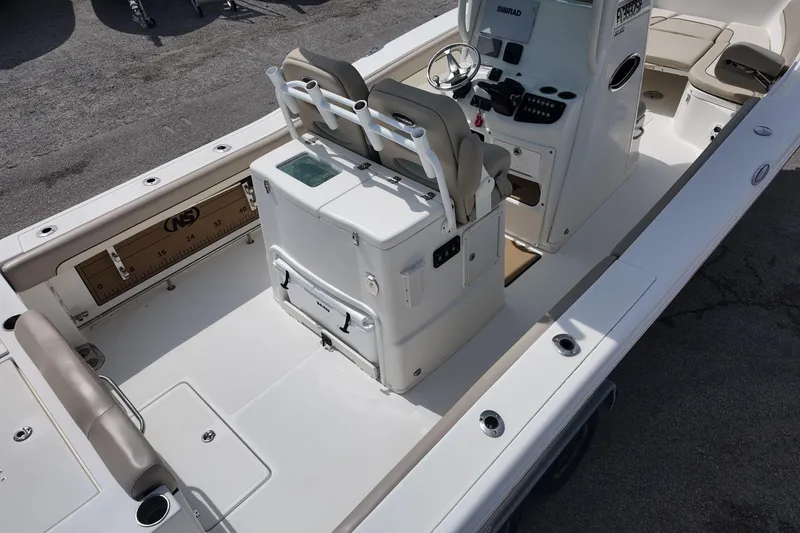 Slide: The Image of 2026 NAUTIC STAR 28 XS boat interior with seating and control console. - 6