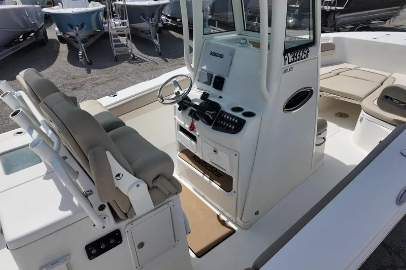 Slide: The Image of 2026 NAUTIC STAR 28 XS boat interior with helm, seating, and control panel. - 7