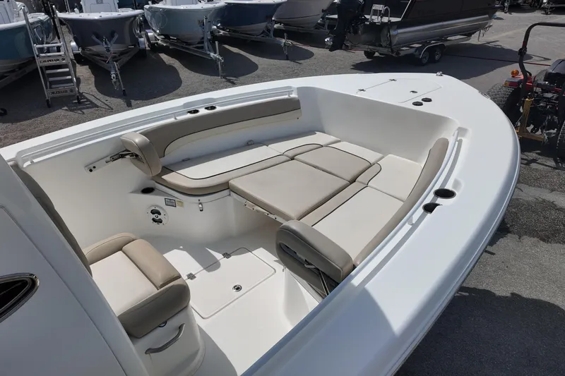 Slide: The Image of 2026 NAUTIC STAR 28 XS boat interior with beige seating and storage compartments. - 9