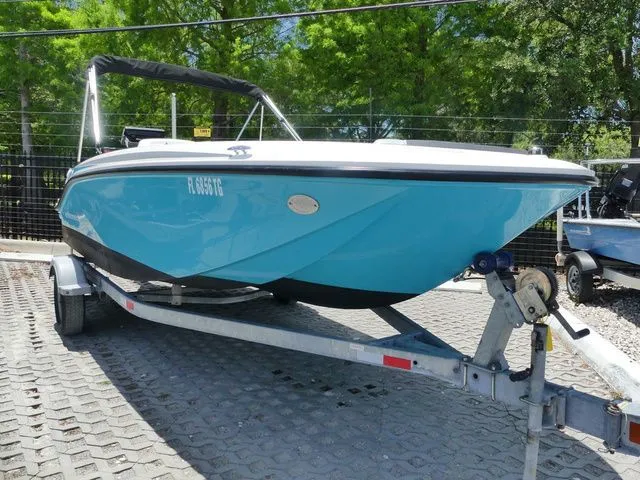 The Image of 2022 Bayliner Element M17 boat on trailer, blue, parked outdoors. - 1