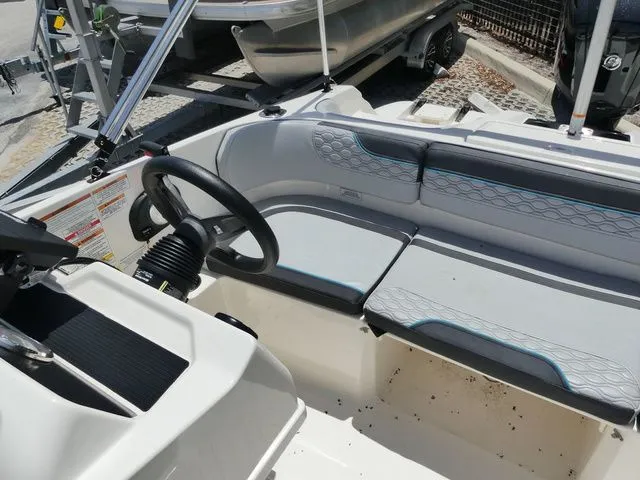 Slide: The Image of Interior of a 2022 Bayliner Element M17 boat with gray seating. - 5