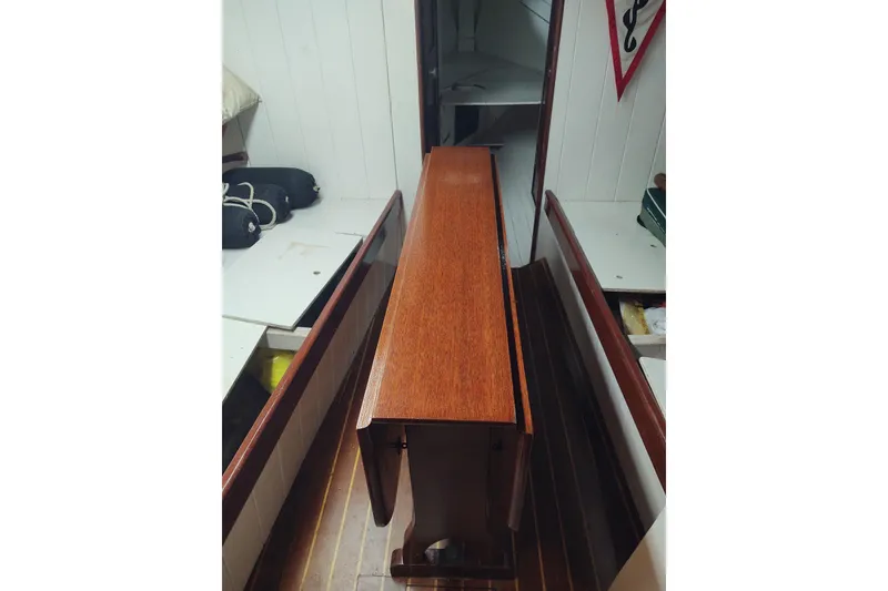 Slide: The Image of Interior of a 1965 Friendship Sloop showcasing wooden cabinetry and nautical decor. - 2