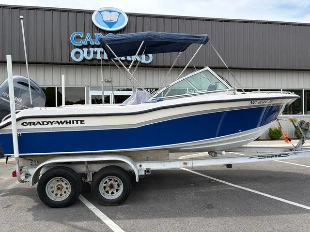 Slide: The Image of 2000 Grady-White Tournament 192 boat on trailer outside store. - 12