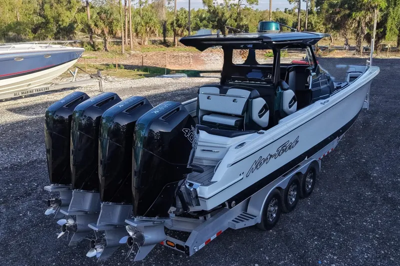 Slide: The Image of 2024 Nor-Tech 400 Supersport boat with quad engines on a trailer. - 11