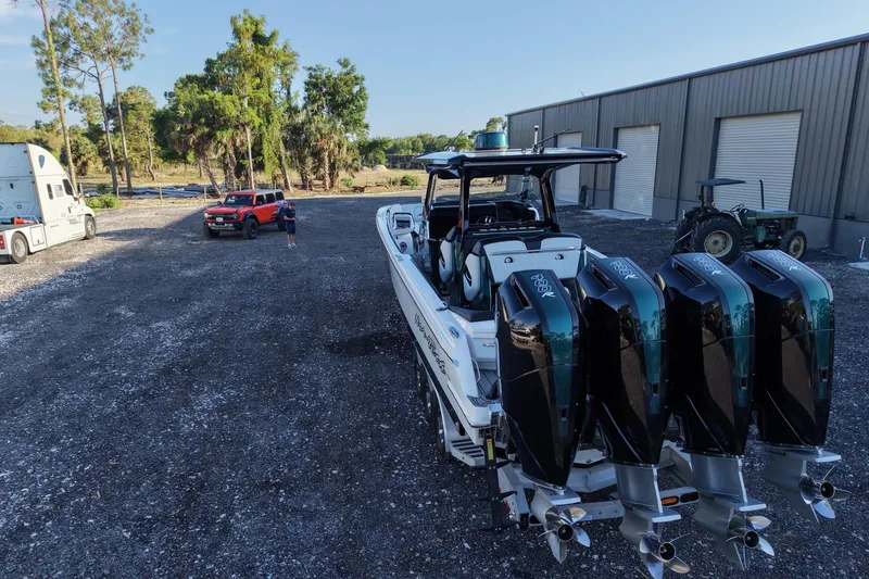 Slide: The Image of 2024 Nor-Tech 400 Supersport boat with quad engines in an outdoor setting. - 13