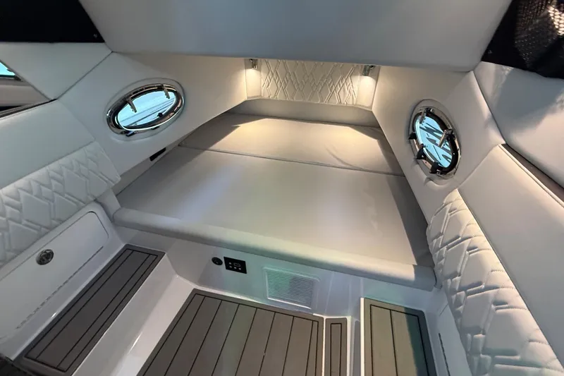 Slide: The Image of Luxurious interior cabin of 2024 Nor-Tech 400 Supersport boat with elegant white upholstery. - 21